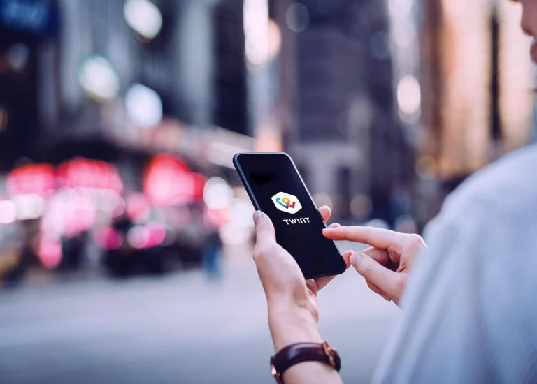 Man with phone using TWINT app