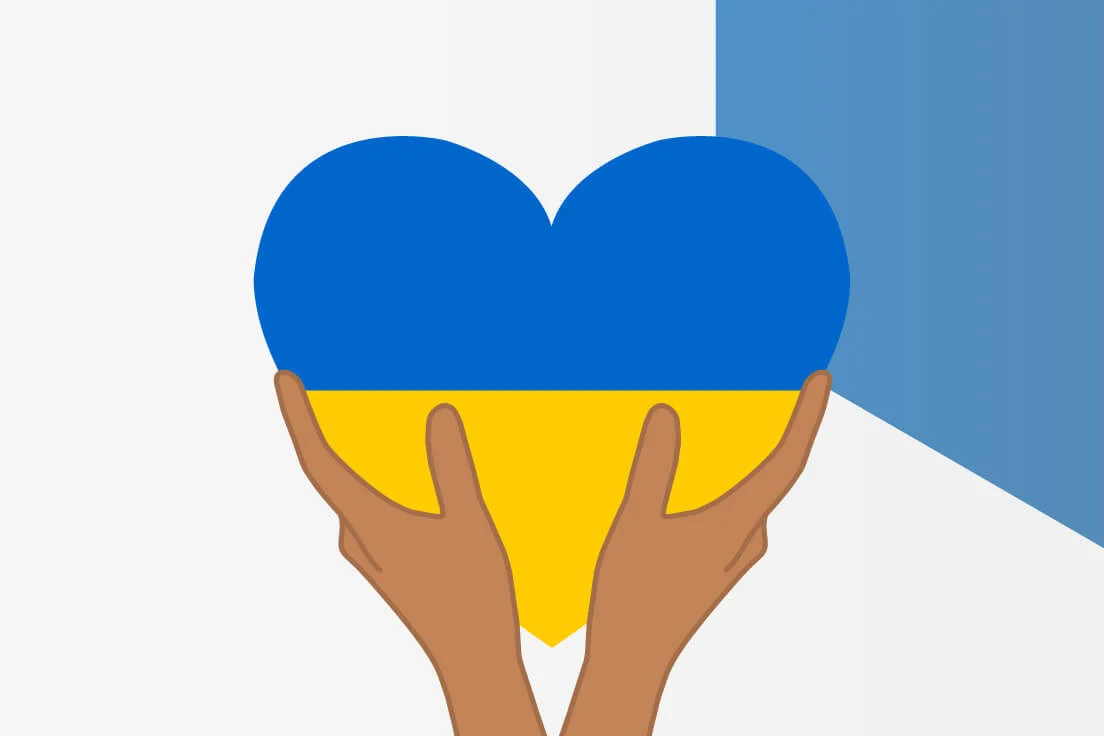hands holding heart shaped ukraine flag