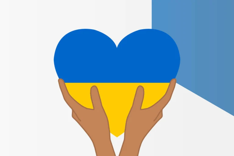 hands holding heart shaped ukraine flag